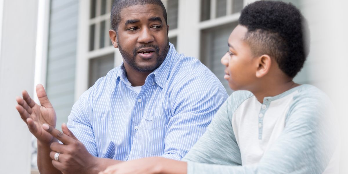 Dad and teenage son talking