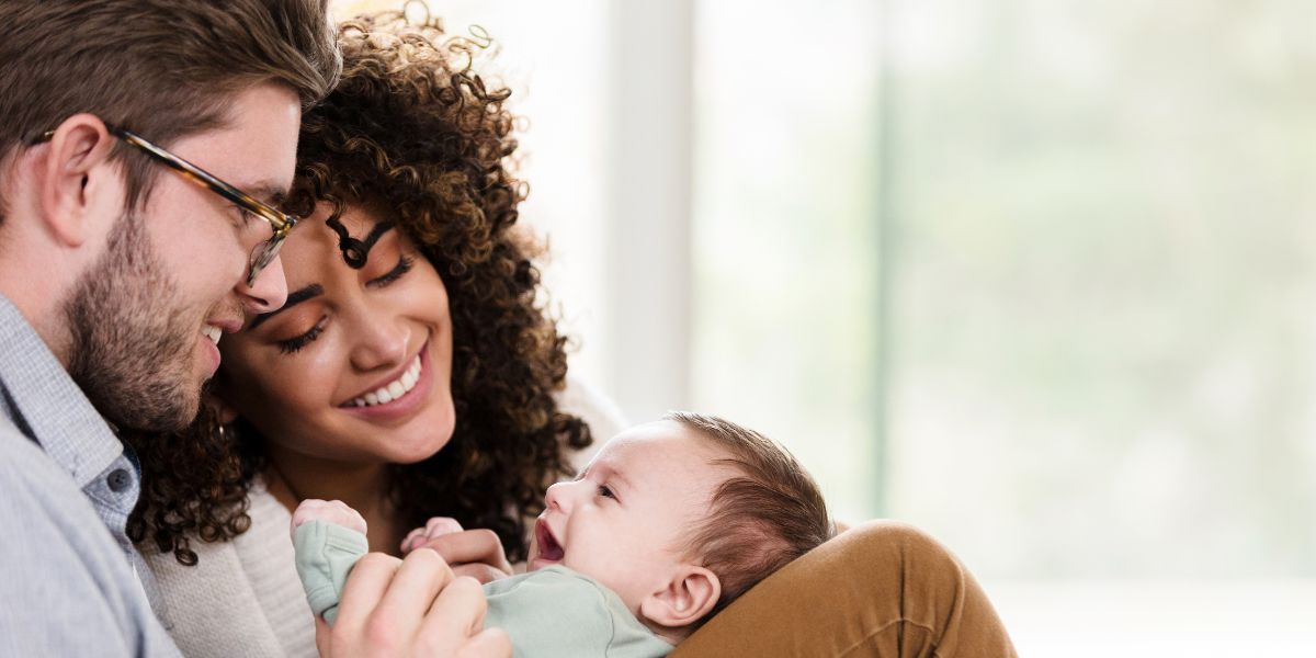 Mix-race couple holding a baby