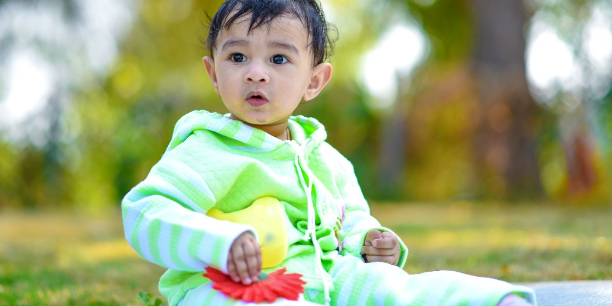Toddler sitting on the grass