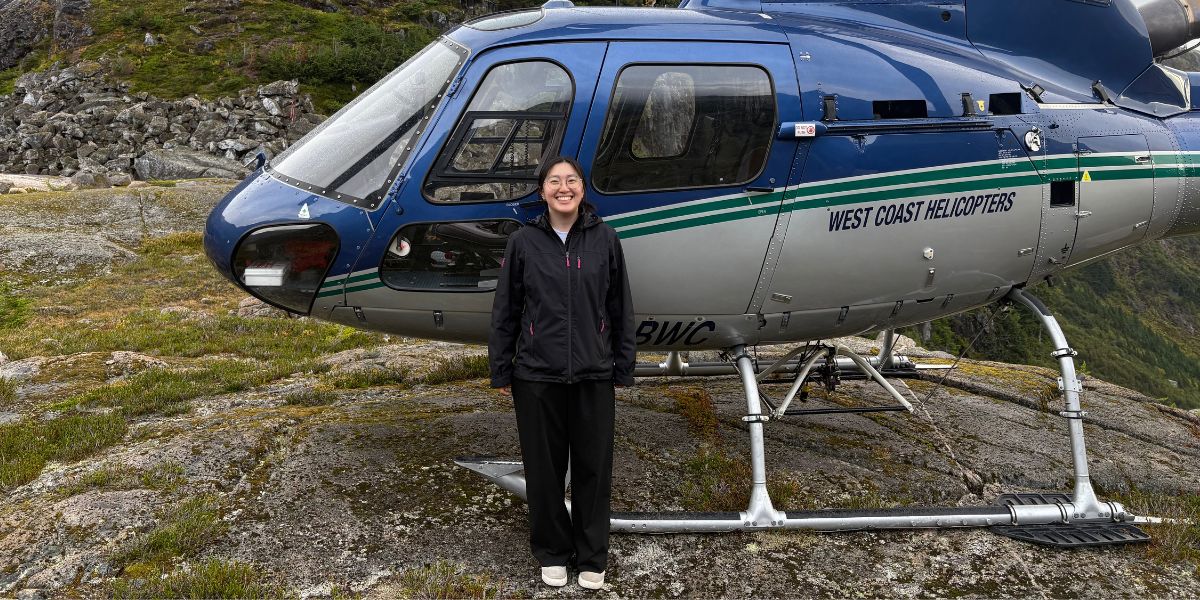 Kate outside helicopter on Vancouver Island