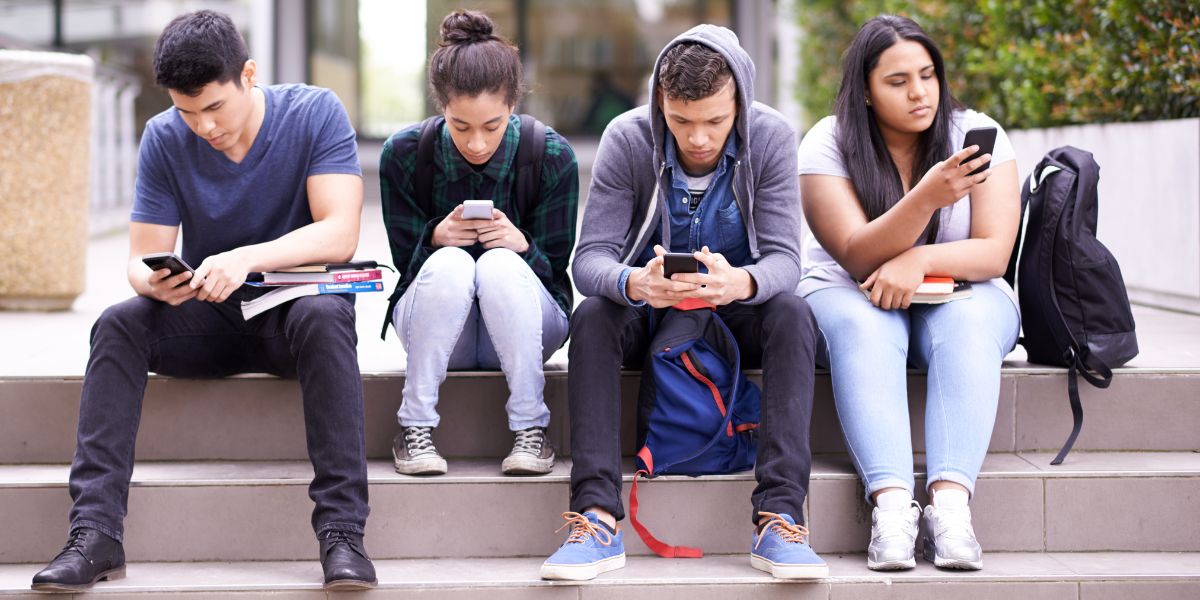 Group of youth looking at their phones