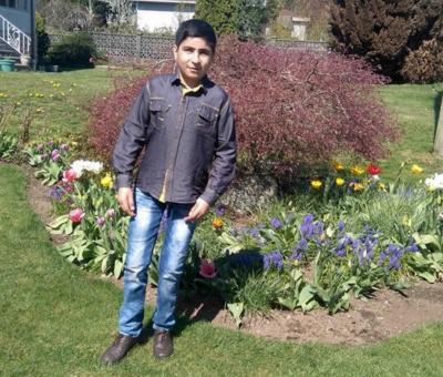 Ebrahim standing on the front lawn of a house in Vancouver