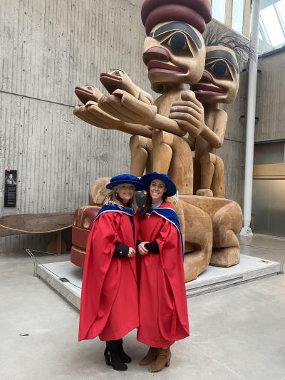 Amanda Butler and friend in cap and gown for PhD graduation