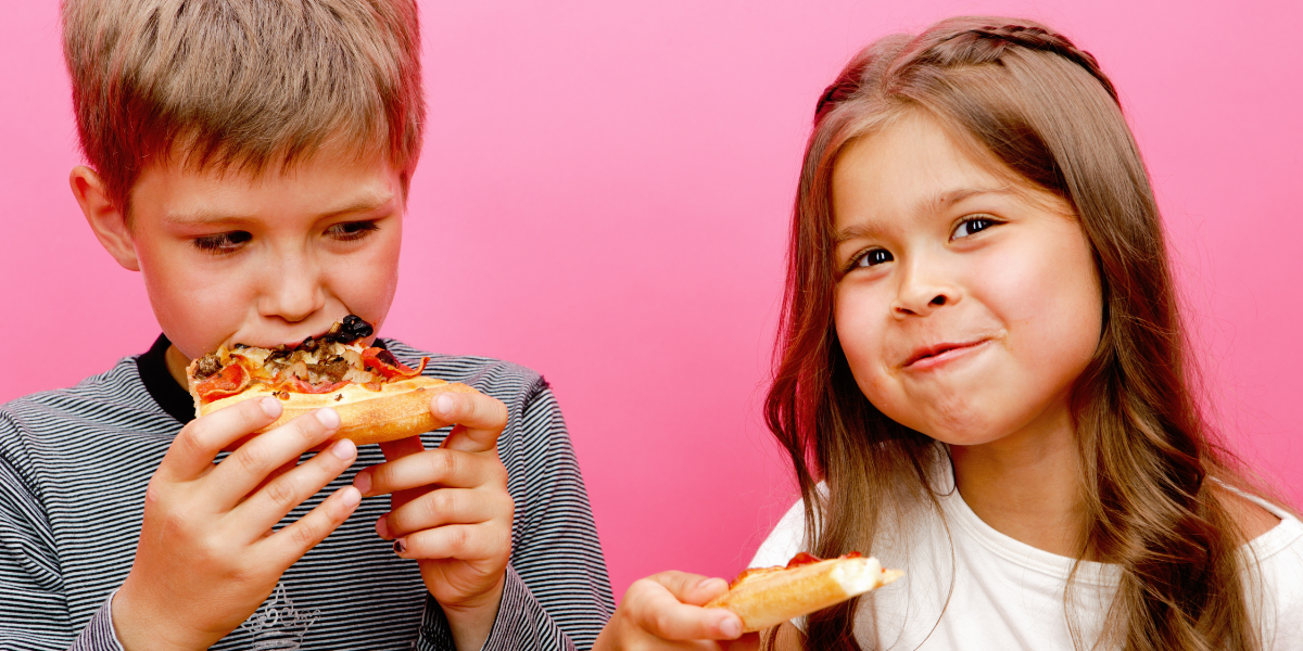 Two kids eat pizza.