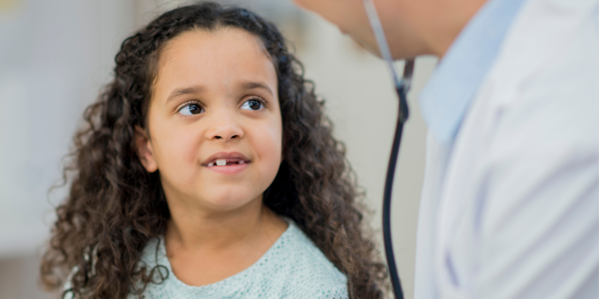 young girl listens to doctor