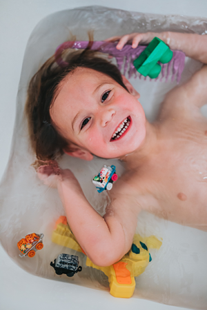 happy kid playing in tub