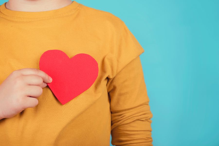 Child holding paper heart