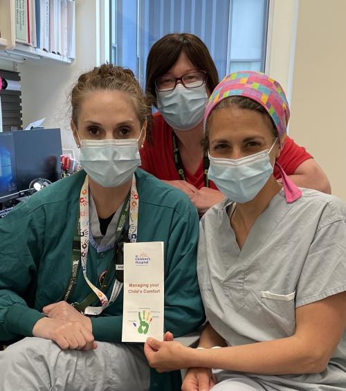 Kathleen Duddy, Liz Lamb and Randa Ridgway holding the pain management brochure