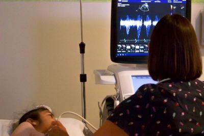 Echocardiography technician with patient