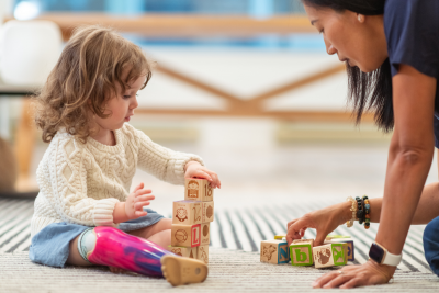 Child playing with blocks with occupational therapist