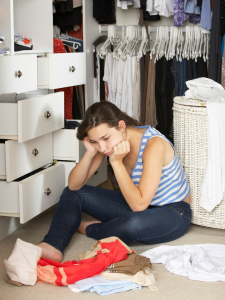 Girl sitting alone in closet