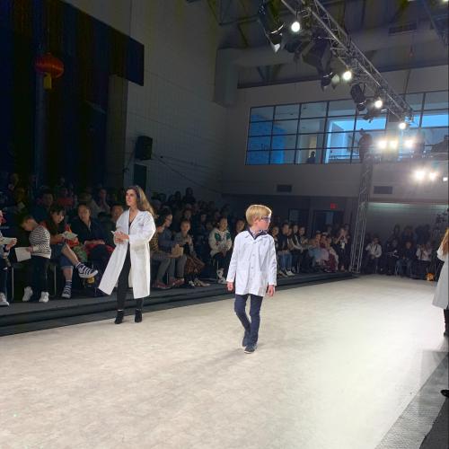 a young boy walks down the runway at Vancouver Kids Fashion Week